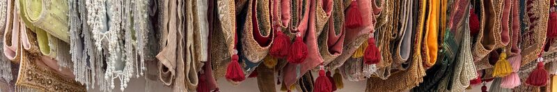 Sashes with red tassels hanging in our atelier